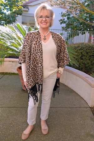 Jennifer of A Well Styled Life wearing ivory cashmere sweater from Everlane with leopard wrap