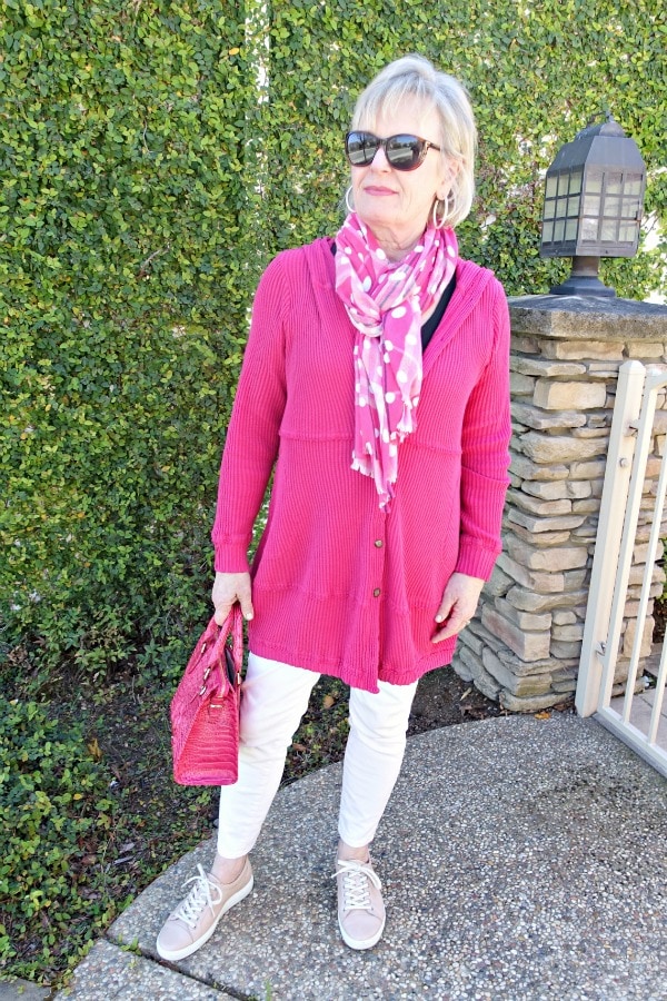 Jennifer Connolly wearing a casual outift of pink hoodie, pink jeans, pink sneakers and pink scarf
