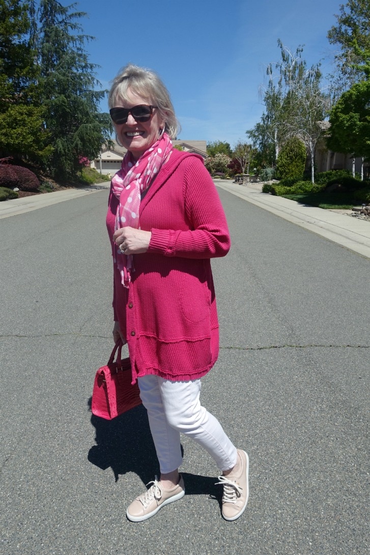 Jennifer Connolly of A Well Styled Life wear pink hoodie, pink jeans, pink handbag, and polka dot scarf