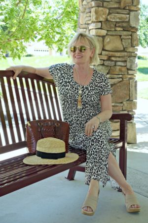 Jennifer Connolly of A Well Styled life wearing leopard with straw hat and Clarks sandals
