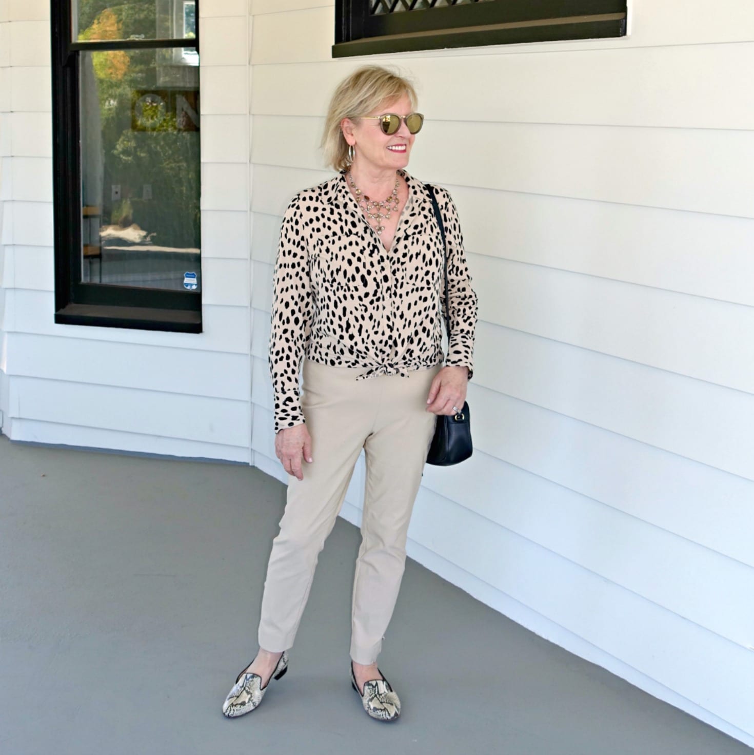 Jennifer Connolly of A Well Styled Life wearing cheetah shirt and sand pants in a casual look from Chico's