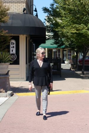 Jennifer Connolly of A Well Styled Life wearing black sweater and slim plaid pants