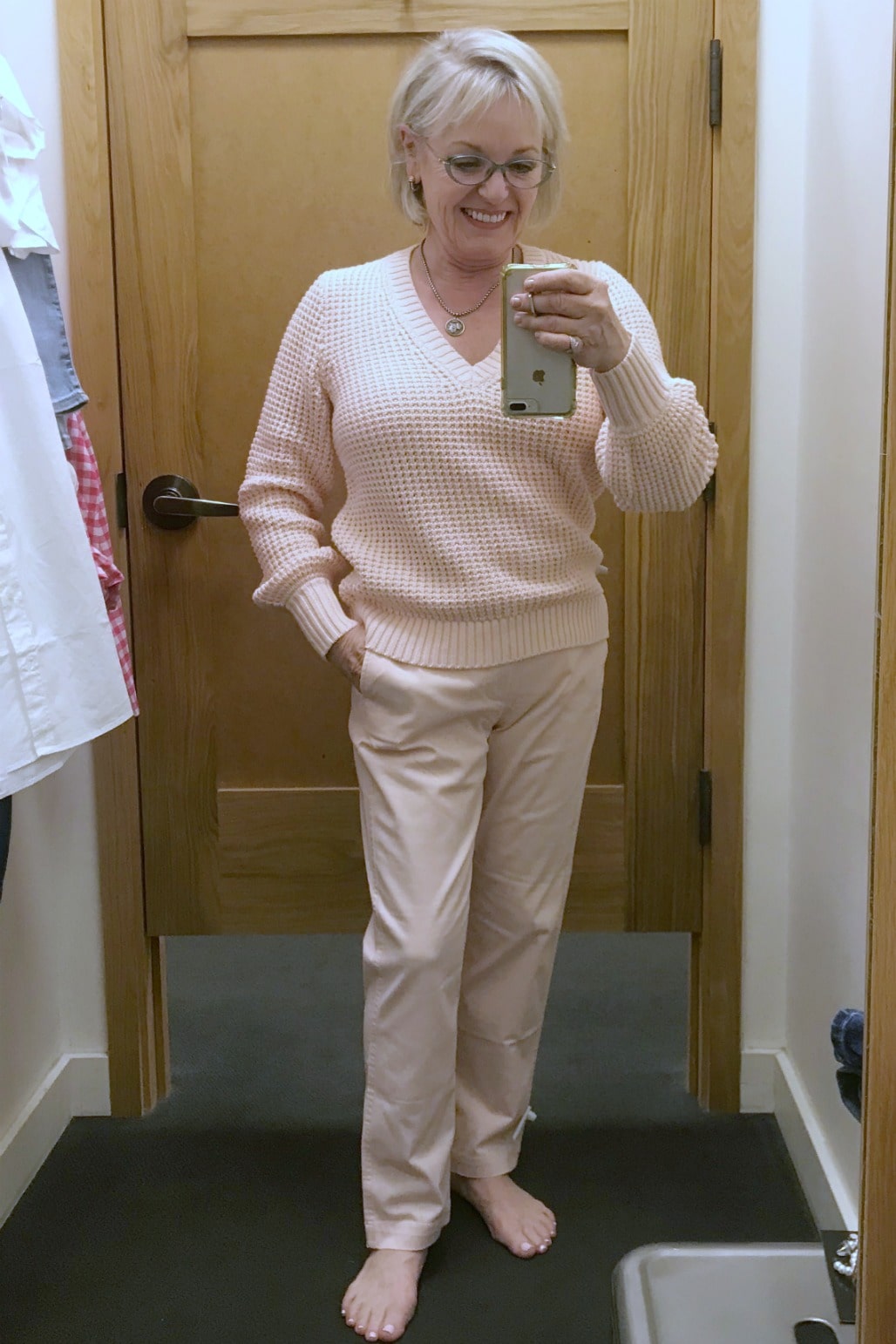 Jennifer Connolly of A Well Styled Life wearing pink cotton sweater and chino's at J Crew factory