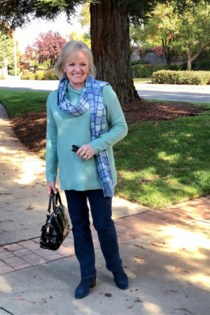 casual outfit with aqaua sweater and blue jeans worn by jennifer of a well styled life