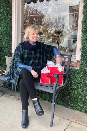 fashion blogger jennifer connolly of a well styled life sitting on bench wearing Talbots ribknit poncho