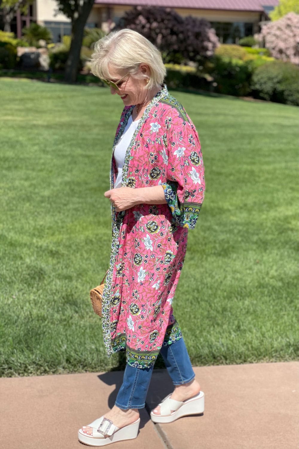 woman walking in pink kimono and stovepipe jeans