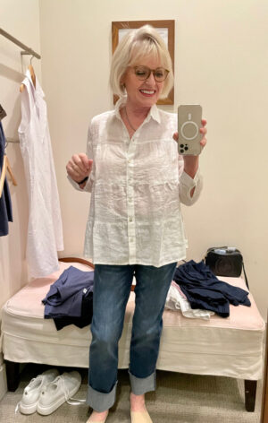 blonde woman wearing white linen shirt with cuffed jeans