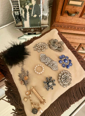 brooch collection pinned onto a small pillow
