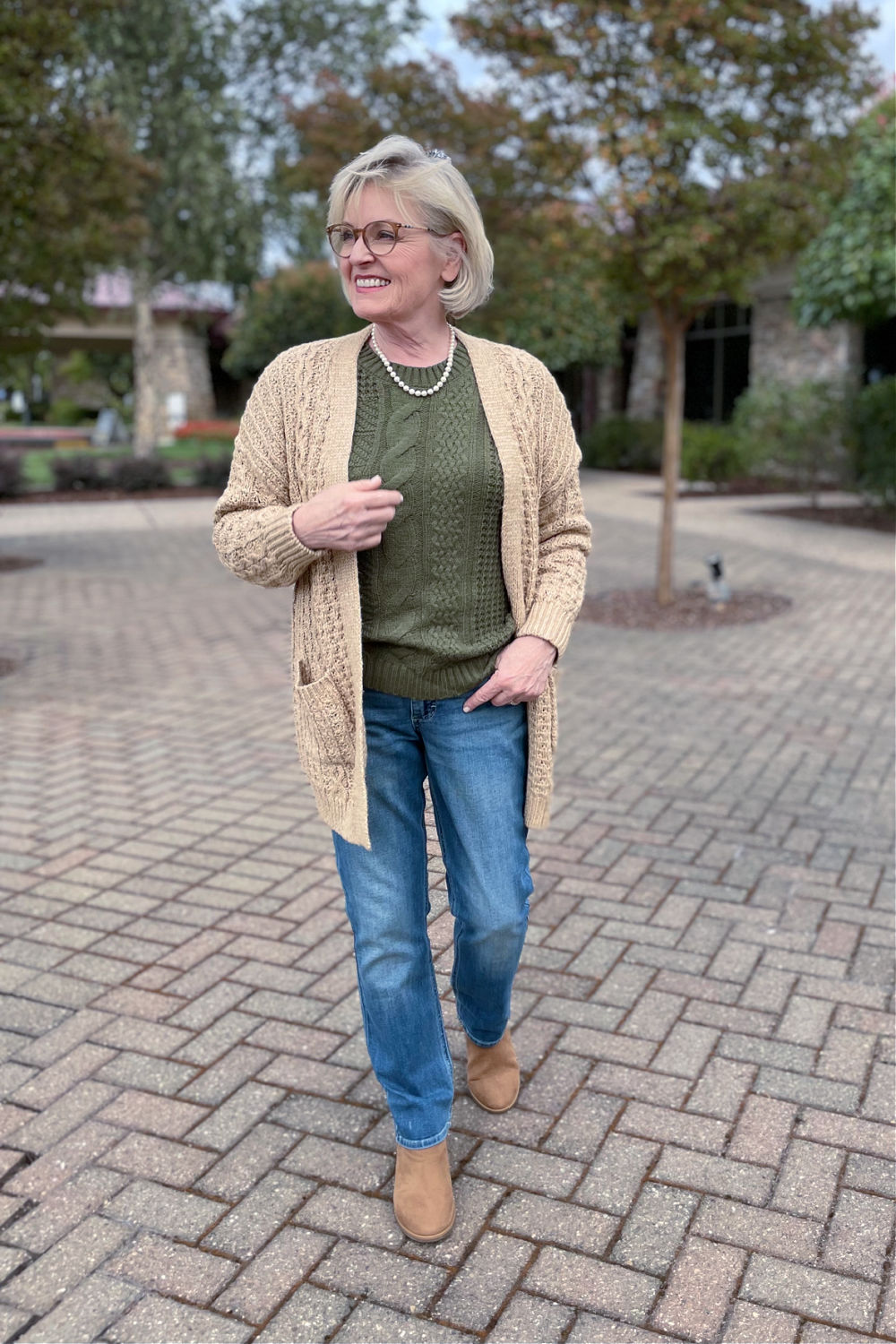 woman wearing Walmarts latest cabled pulloever and cardigan with lee jeans