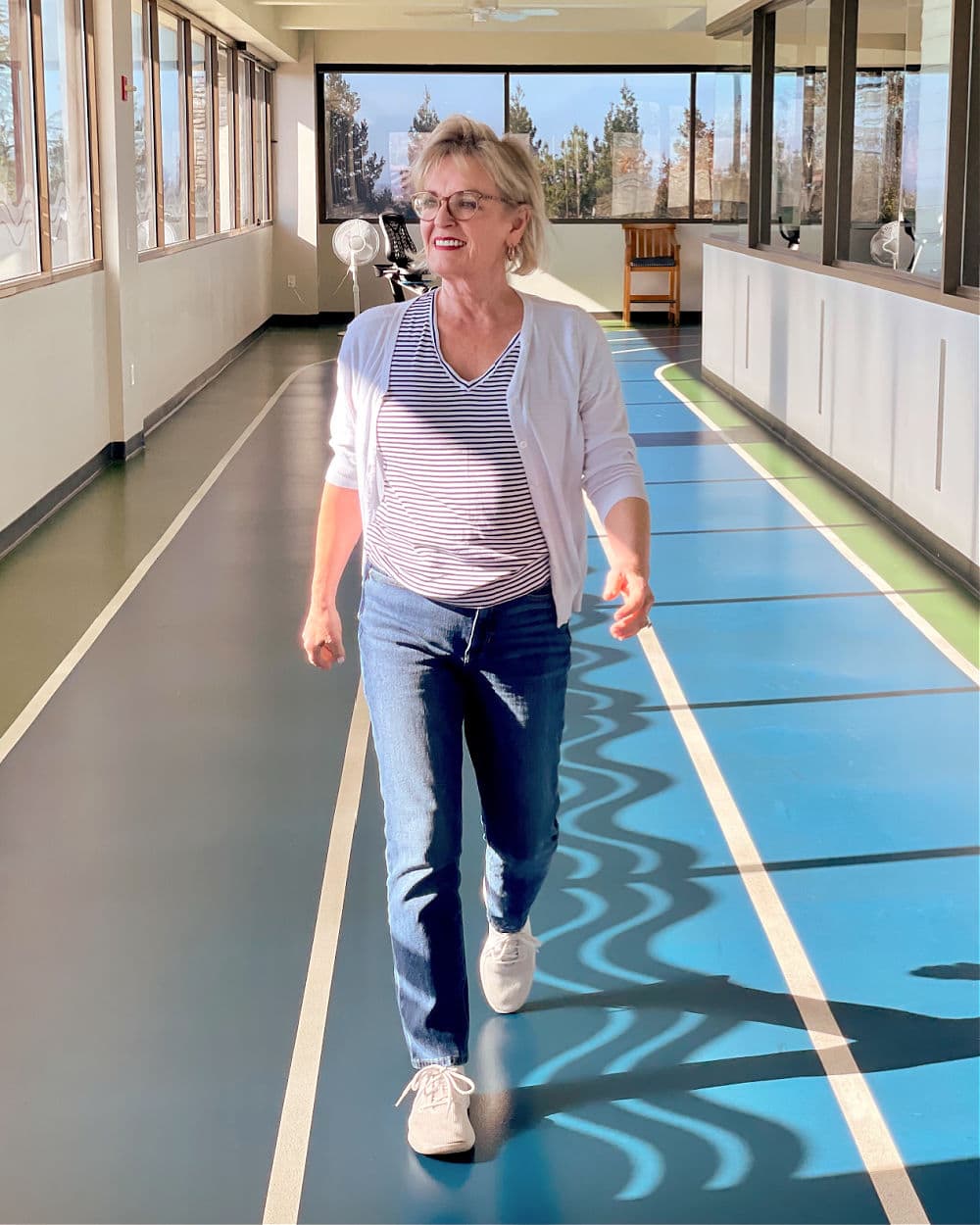 woman walking a track in silversneakers program