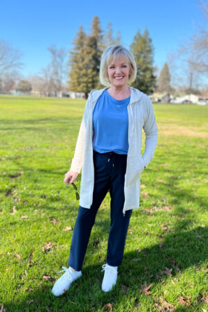 woman wearing blue athleiisure top and pants at park