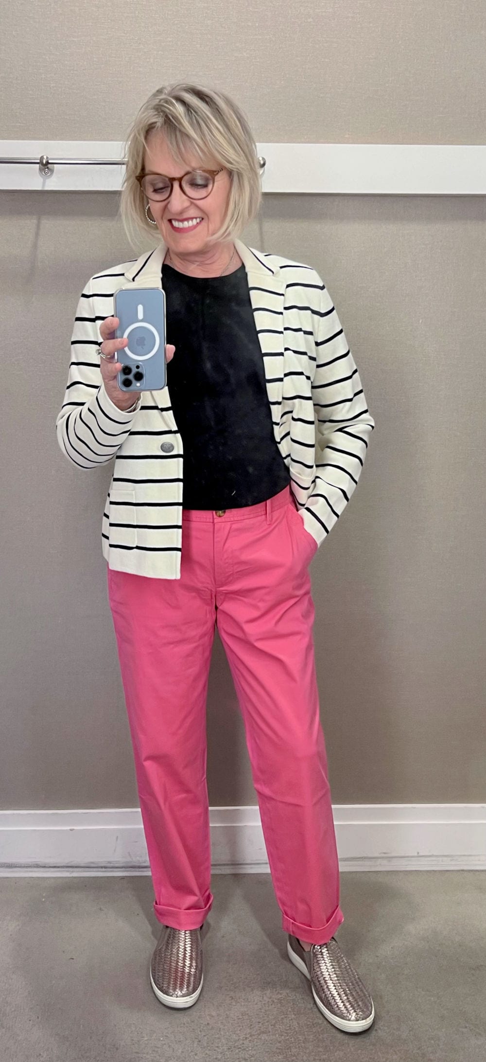 woman wearing pink chinos and striped jacket