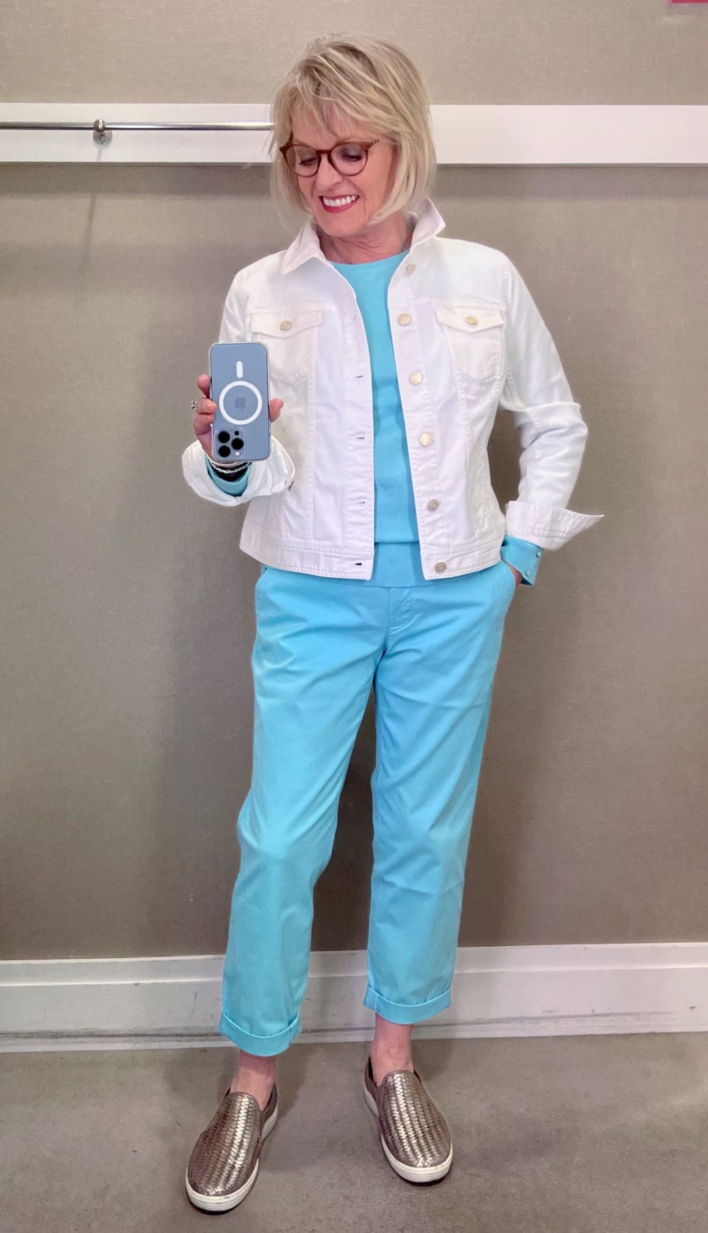 woman wearing white denim jacket and turquoise chino's