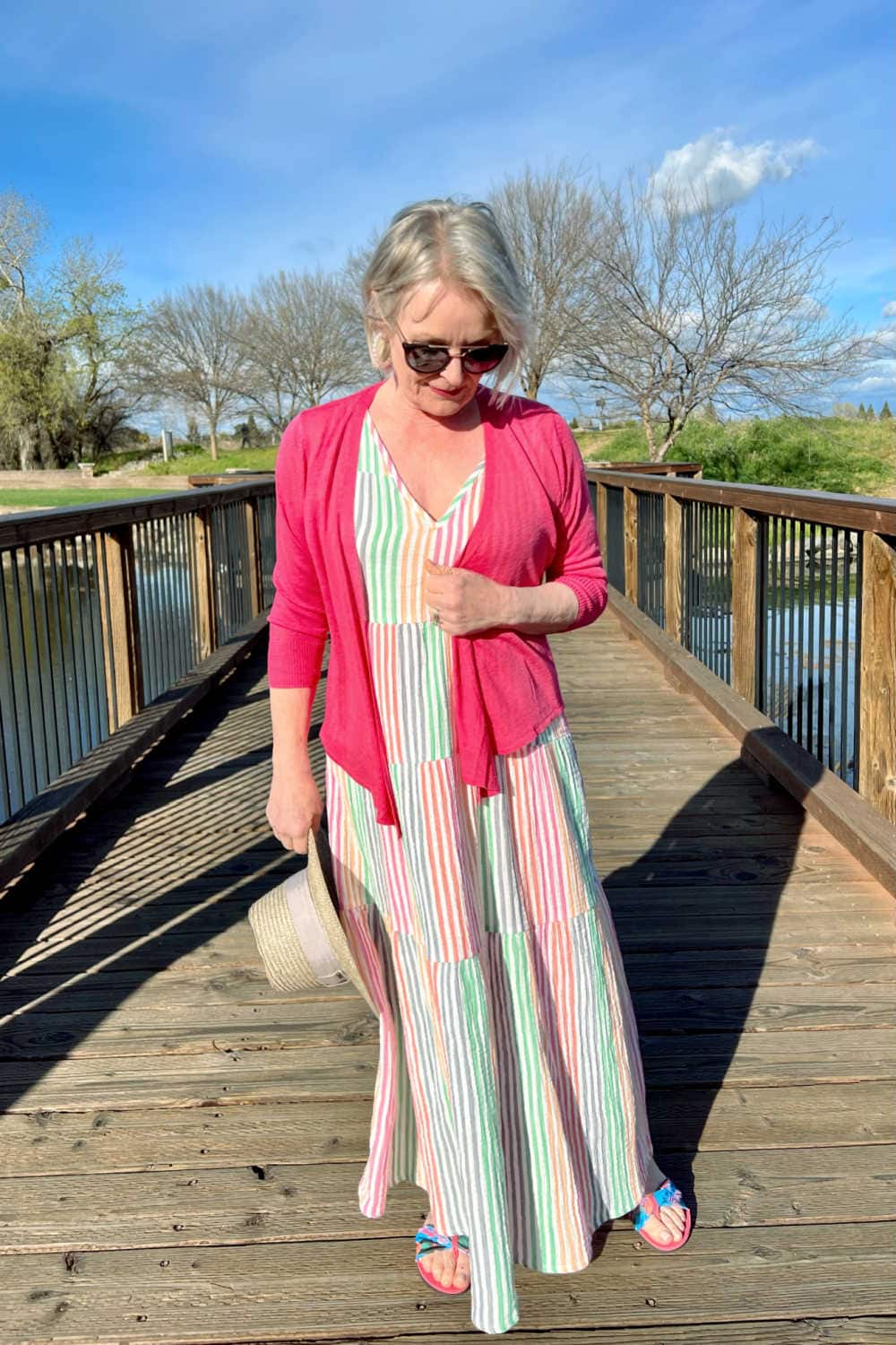 woman wearing pink cardigan and striped dress