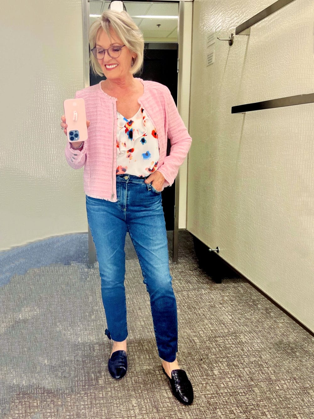 WOMAN WEARNG PINK BLAZER AND AG JEANS