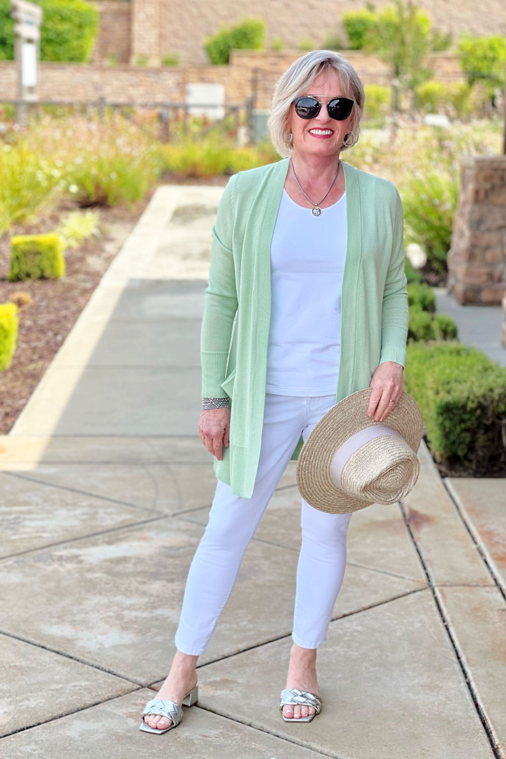 woman wearing green cardigan and white jeans