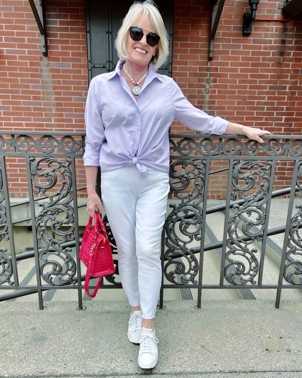 woman wearinf purple shirt and white jeans from factory outlet