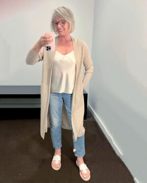 woman wearing linen cardigan over jeans and silk tank