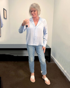 woman in banana republic dressing room in jeans and silk blouse