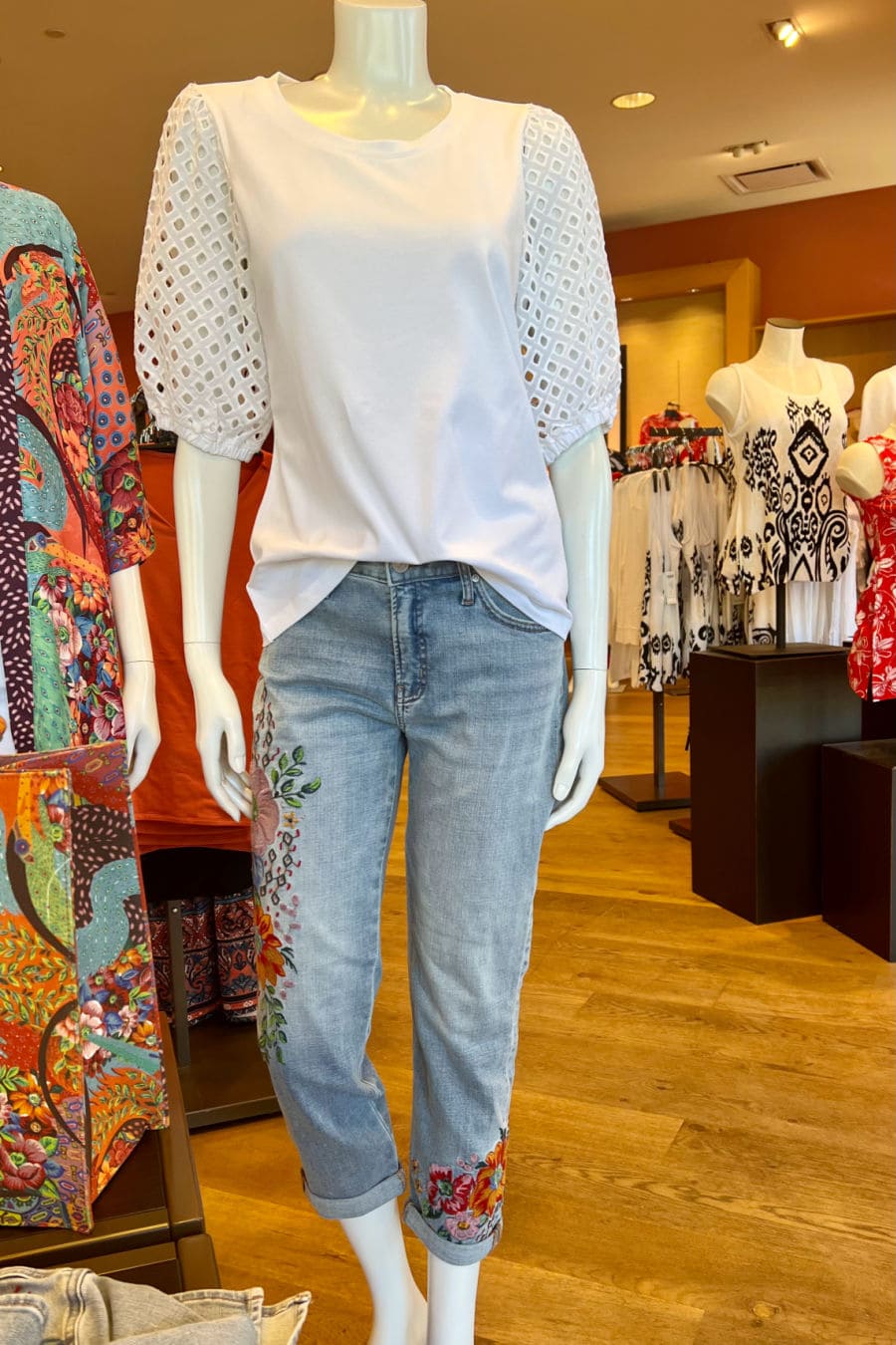 mannequin modeling eylet top and jeans with embroidery