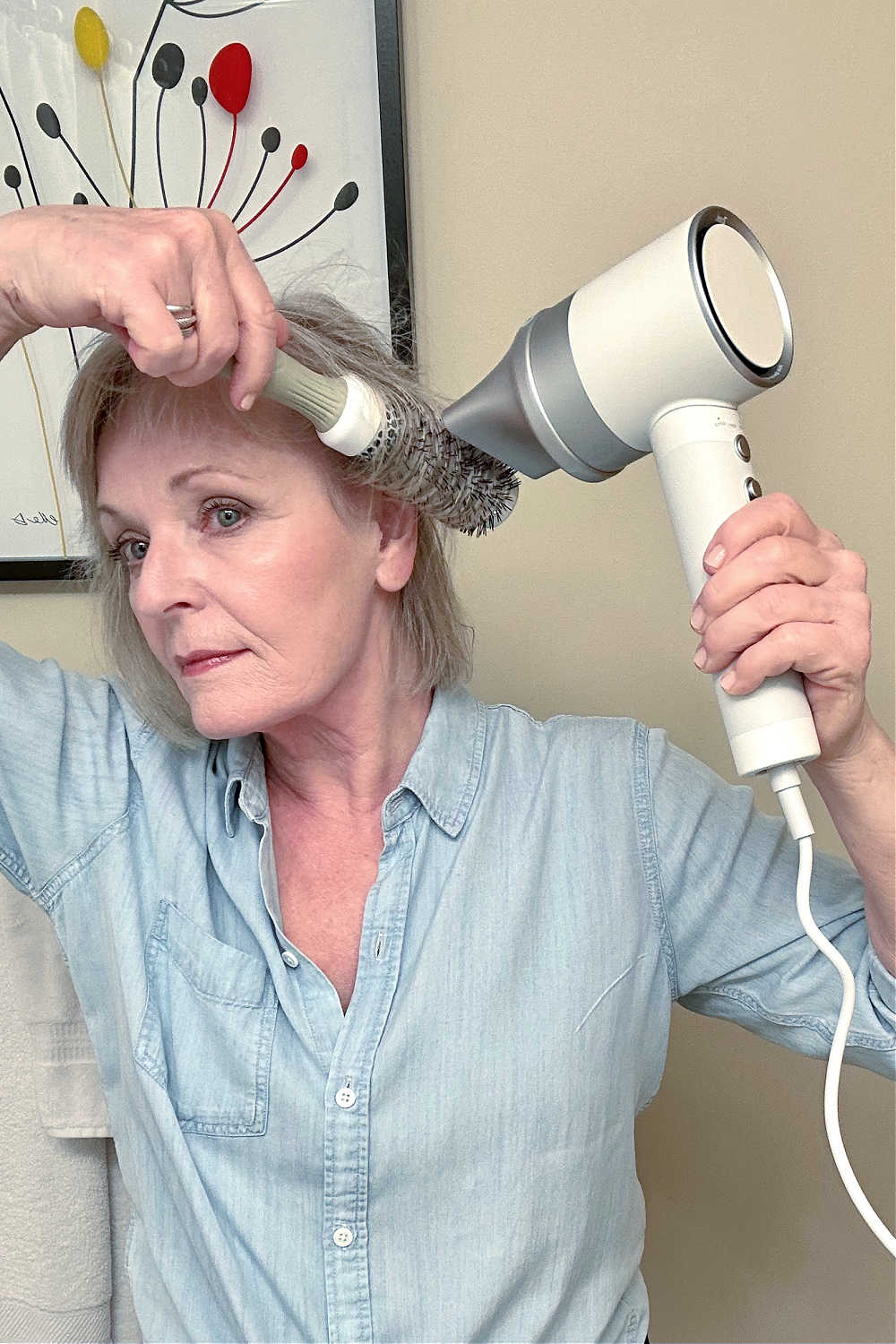 woman with thinning hair using the zuvi halo hairdryer