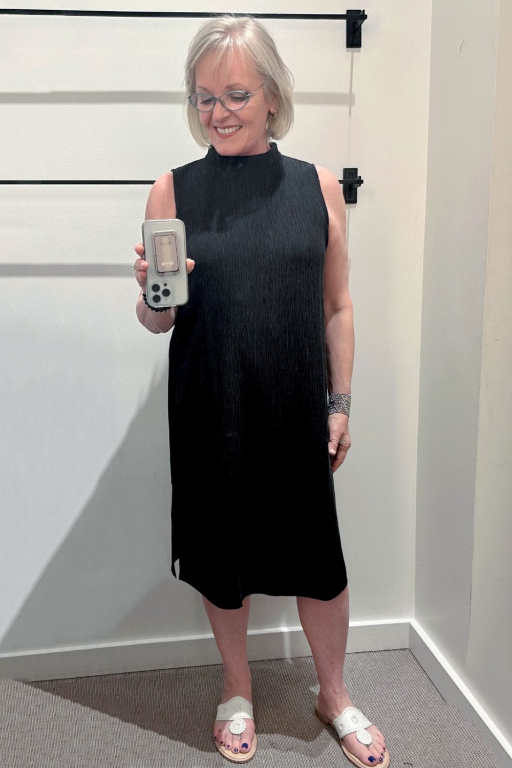 woman taking picture in mirror wearing dress from Eileen Fisher