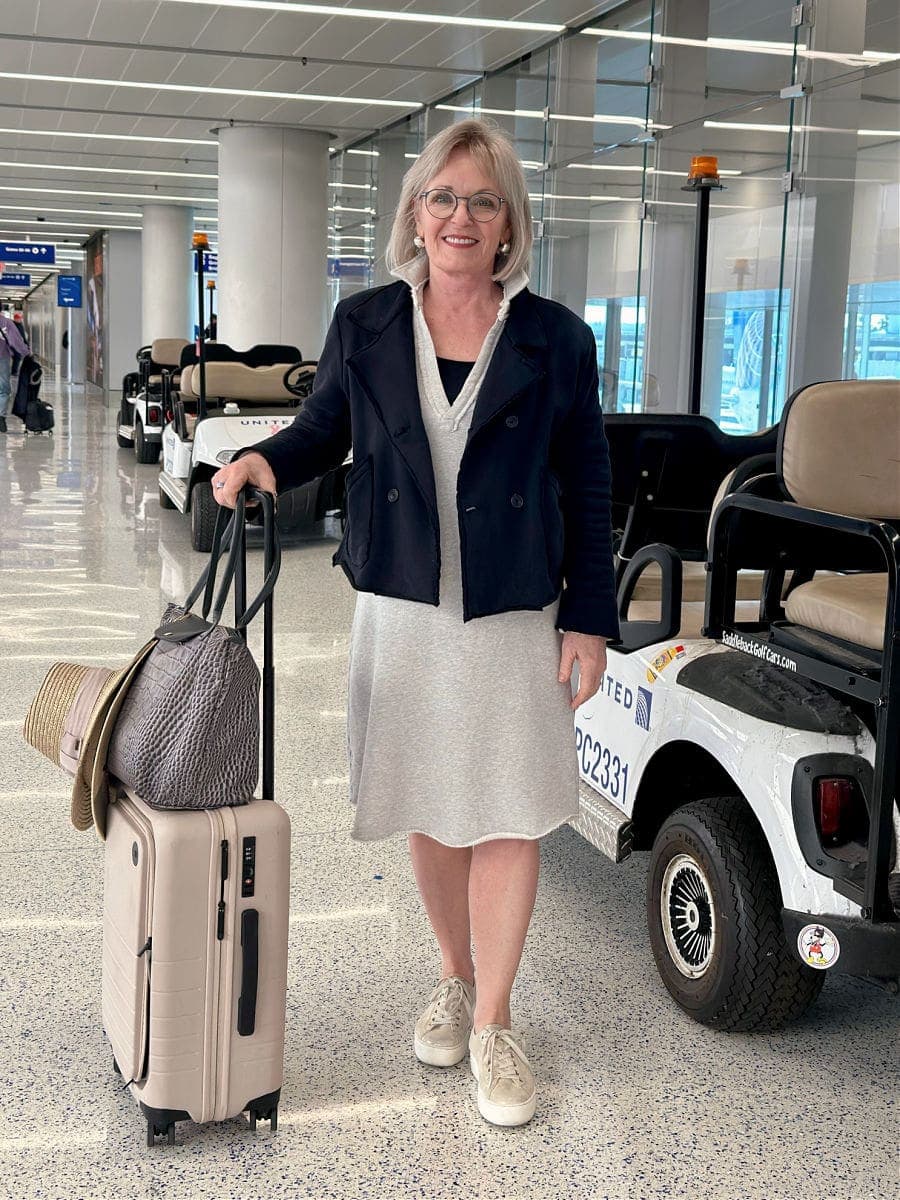 woman wearing Paul green metallic sneakers at airport