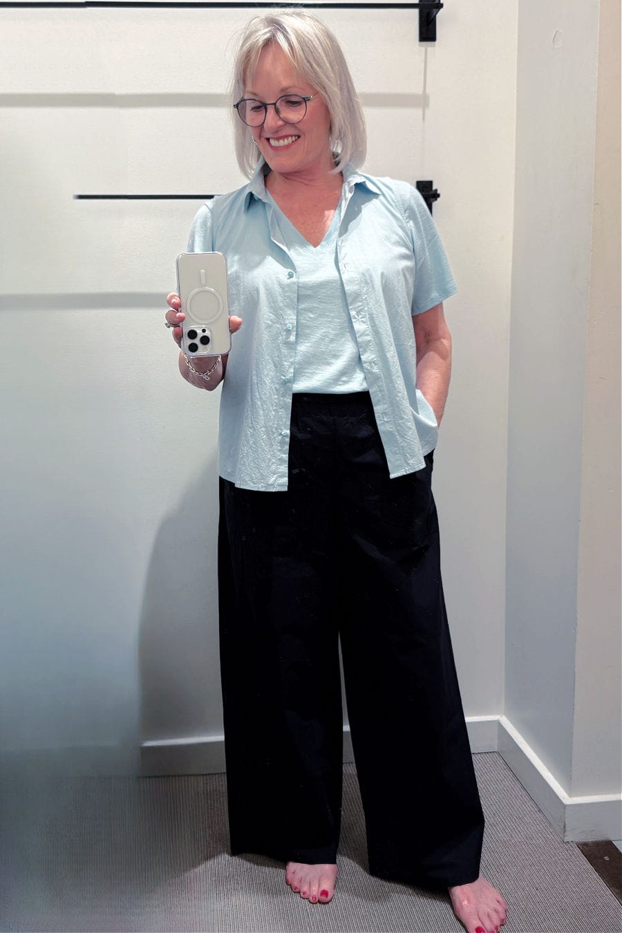 Slub jersey v-neck tee layered with a cropped sleeveless poplin shirt and wide-leg cotton pants in dark ink.