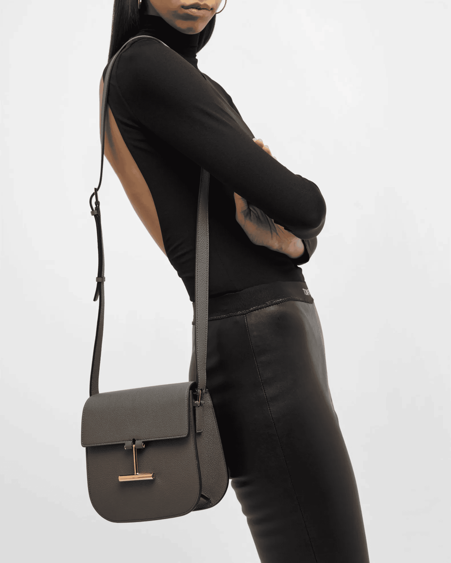 Tom Ford Tara Mini Crossbody in graphite grained leather with structured flap design, gold hardware, and medium size interior.