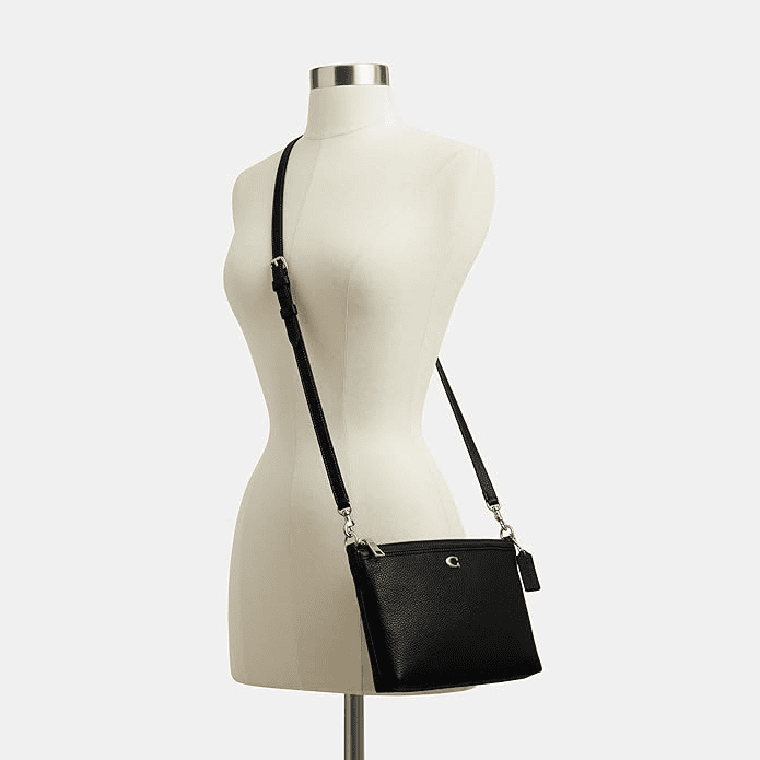 Coach Legacy Zip Top Crossbody bag in black leather with structured body and adjustable strap.