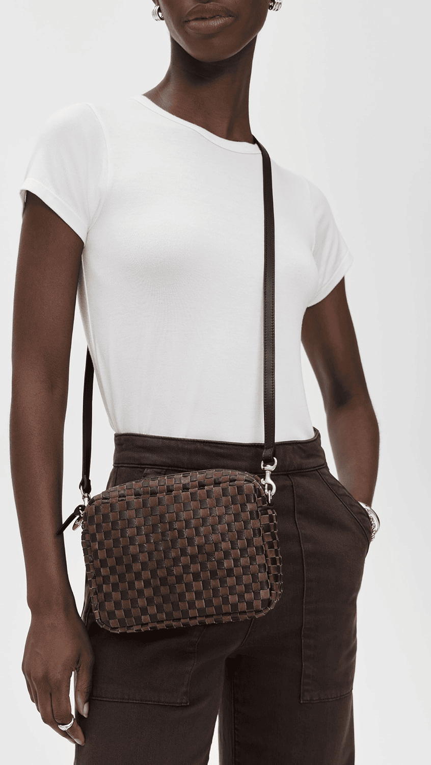 Clare V. Midi Crossbody Woven Bag in black and brown with leather strap and compact woven body.