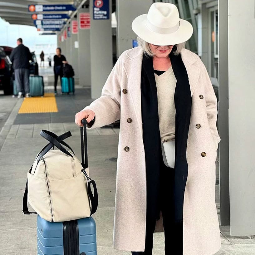 woman at airport with Away everywhere bag