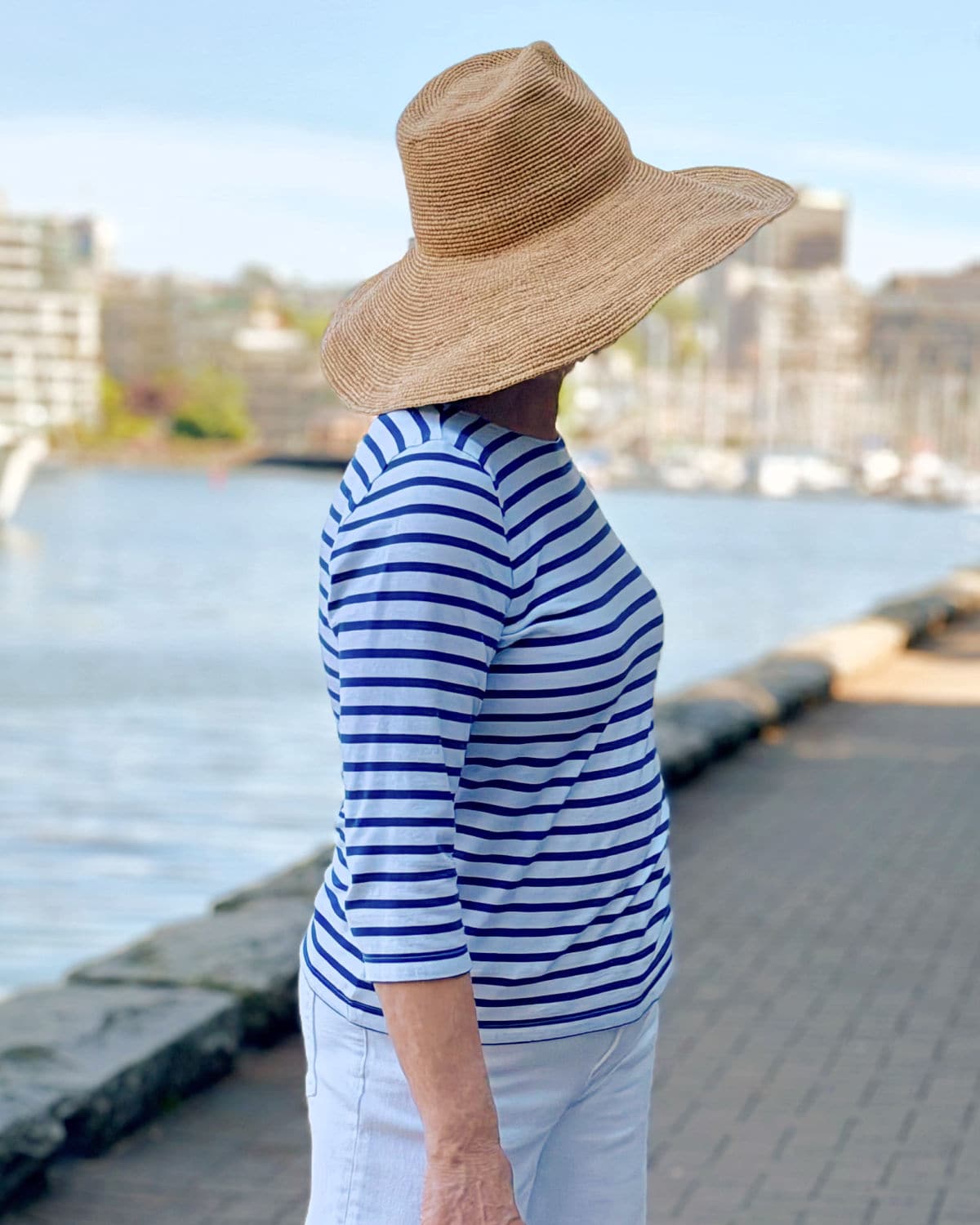 Woman wearing a 3/4 sleeve Breton top showing a flattering sleeve length for women over 50
