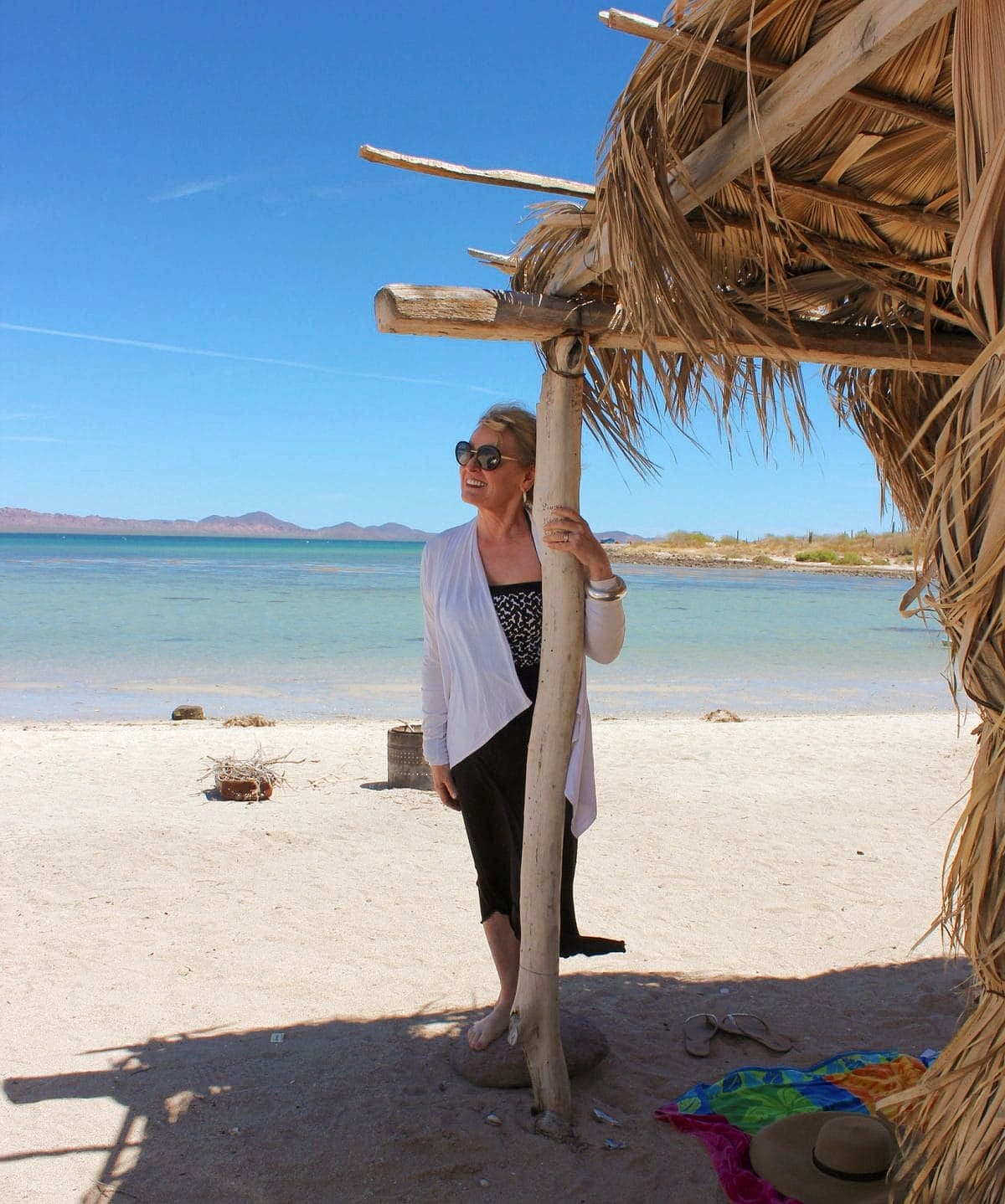 woman at beach wearing self tanner on legs