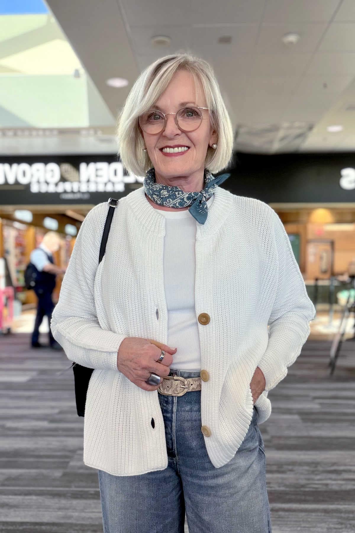woman wearing summer scarf around her neck at airport