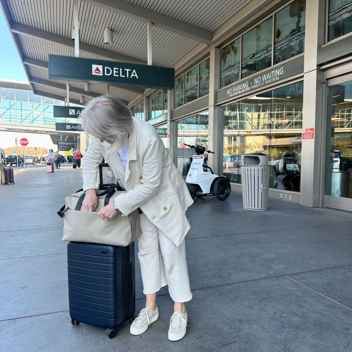 jennifer connolly from a well styled life traveling with Away Weekender Bag and Roller Carry-on bag