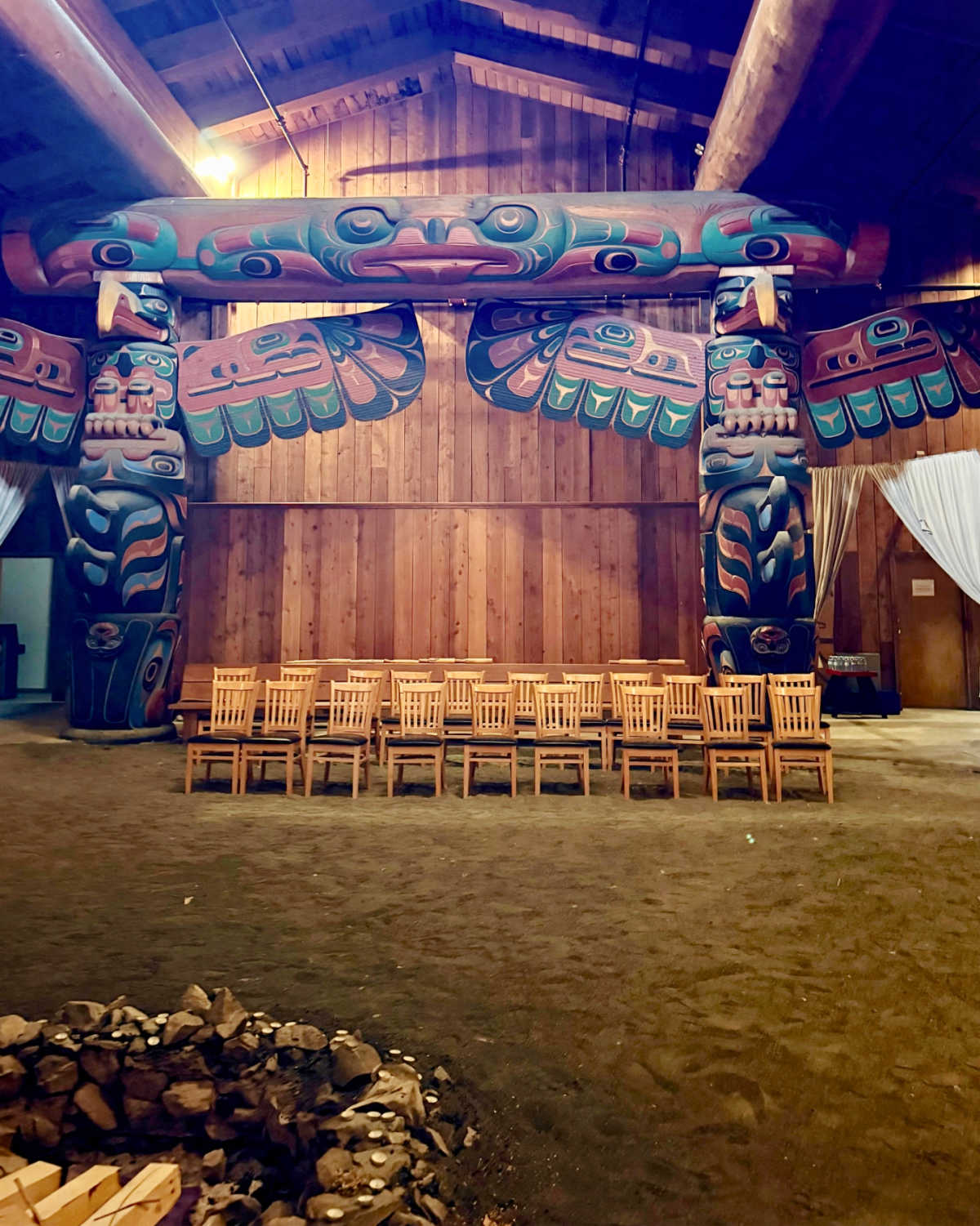 Inside the Kitasoo Xai’xais Big House with carved and painted posts and beams